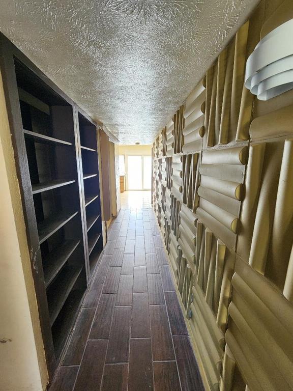 3114 Nutmeg Lane Garland, TX 75044 - Photo 11 of 18 a view of walk in closet with wooden floor and stairs
