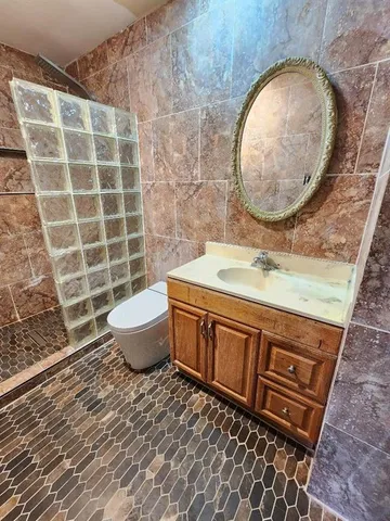a bathroom with a sink mirror vanity and toilet