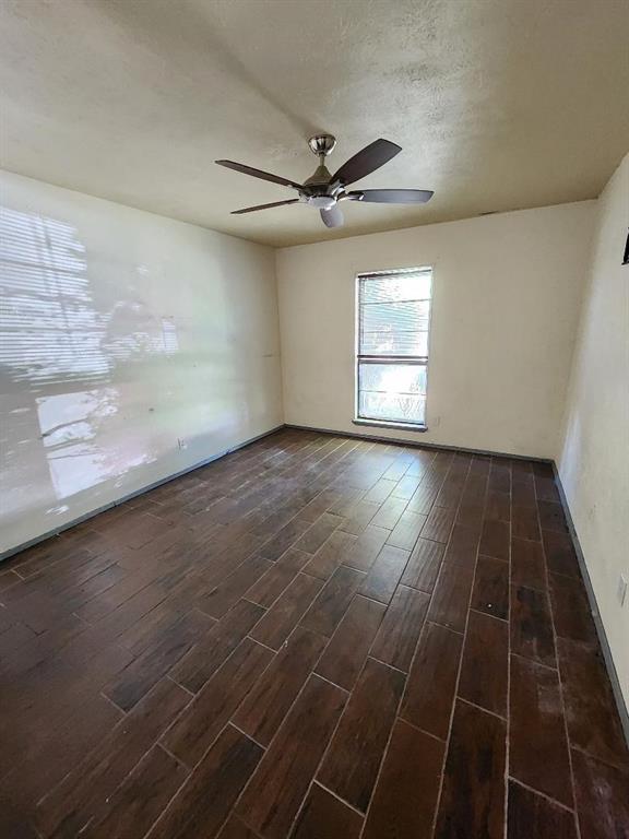 3114 Nutmeg Lane Garland, TX 75044 - Photo 5 of 18 an empty room with wooden floor fan and windows