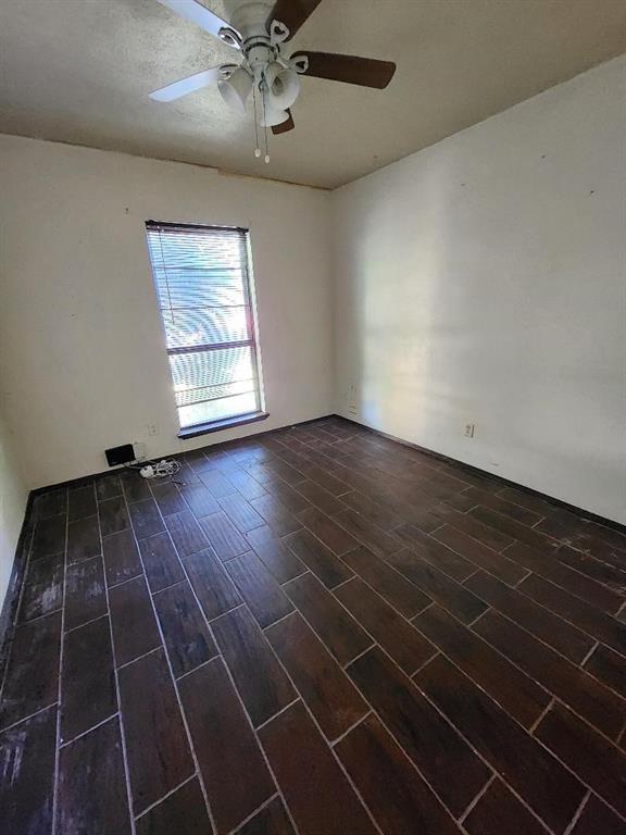 3114 Nutmeg Lane Garland, TX 75044 - Photo 6 of 18 an empty room with wooden floor and windows