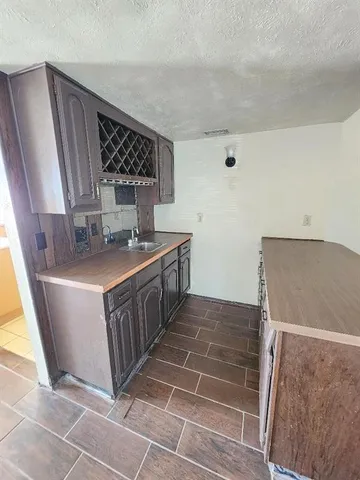 a kitchen with stainless steel appliances a sink stove and cabinets