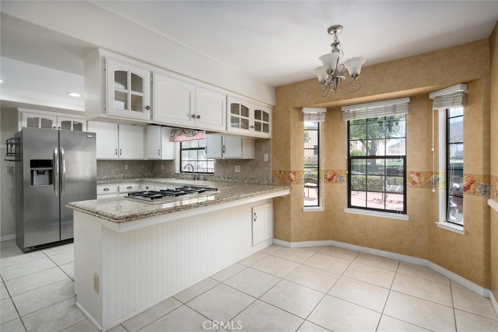 34150 Stowe Road Winchester, CA 92545 - Photo 7 of 80 a kitchen with stainless steel appliances granite countertop a stove and a refrigerator