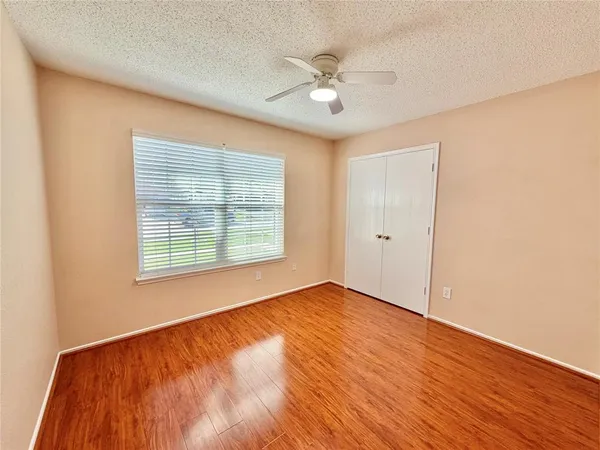 a bathroom with a granite countertop sink toilet a mirror and shower