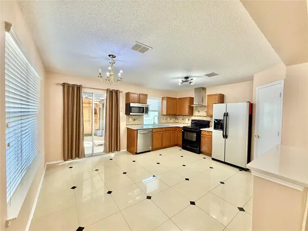 a kitchen with kitchen island cabinets and white appliances