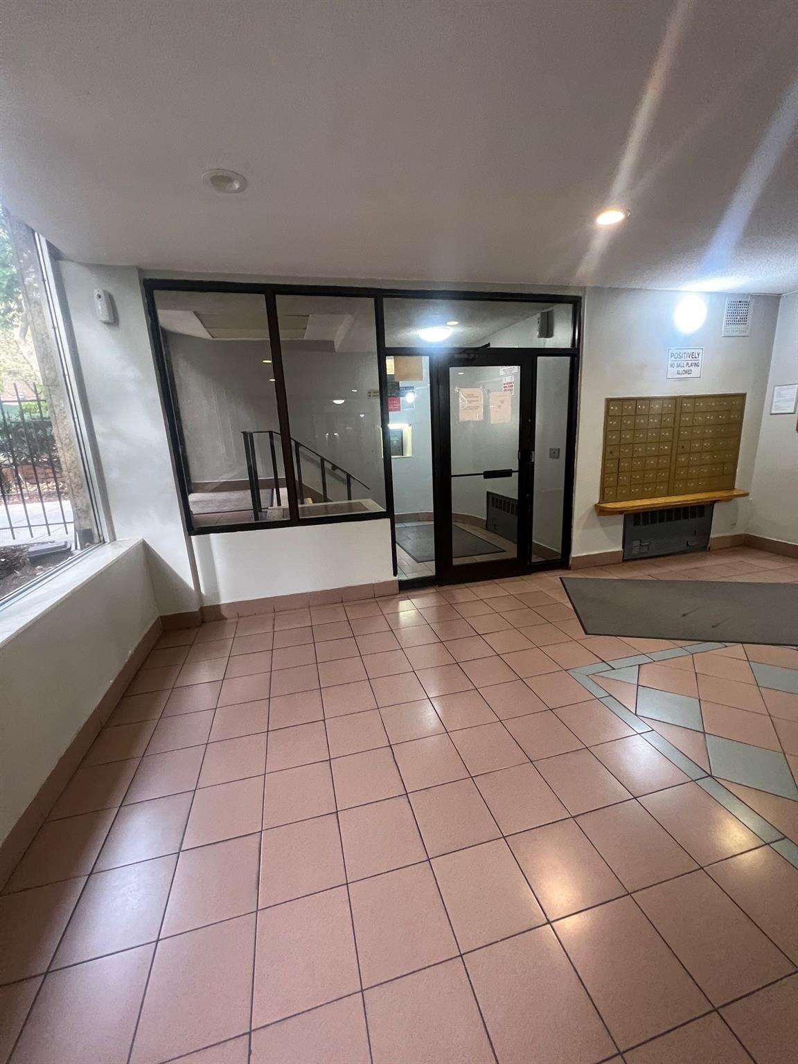 285 East 35th Street, Unit 2D Brooklyn, NY 11203 - Photo 20 of 21 Empty room with tile patterned floors and mail area