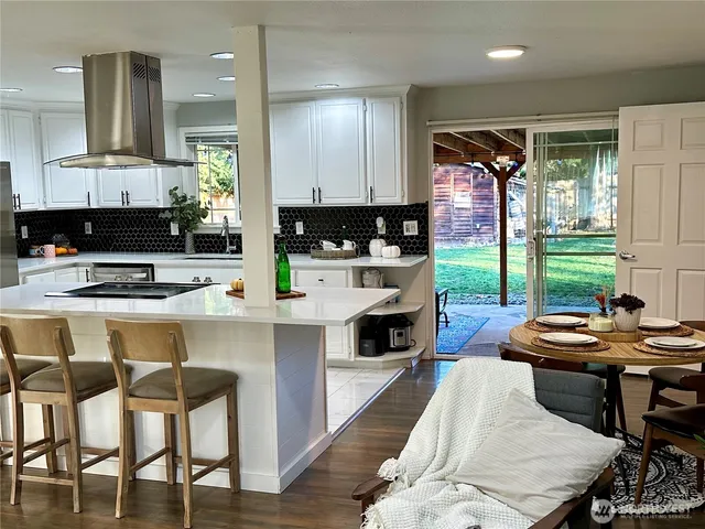 a kitchen with a table chairs stove and cabinets