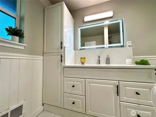 a bathroom with a sink and a mirror
