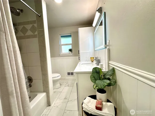 a bathroom with a bathtub sink and toilet