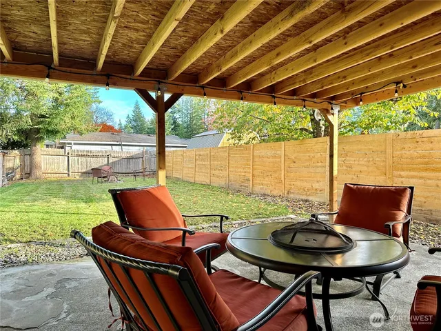 a patio with water view fountain with outdoor seating