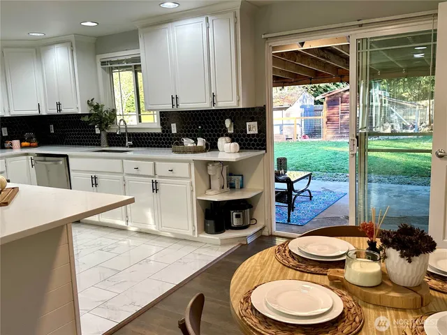 a kitchen with a sink a stove and a wooden cabinets