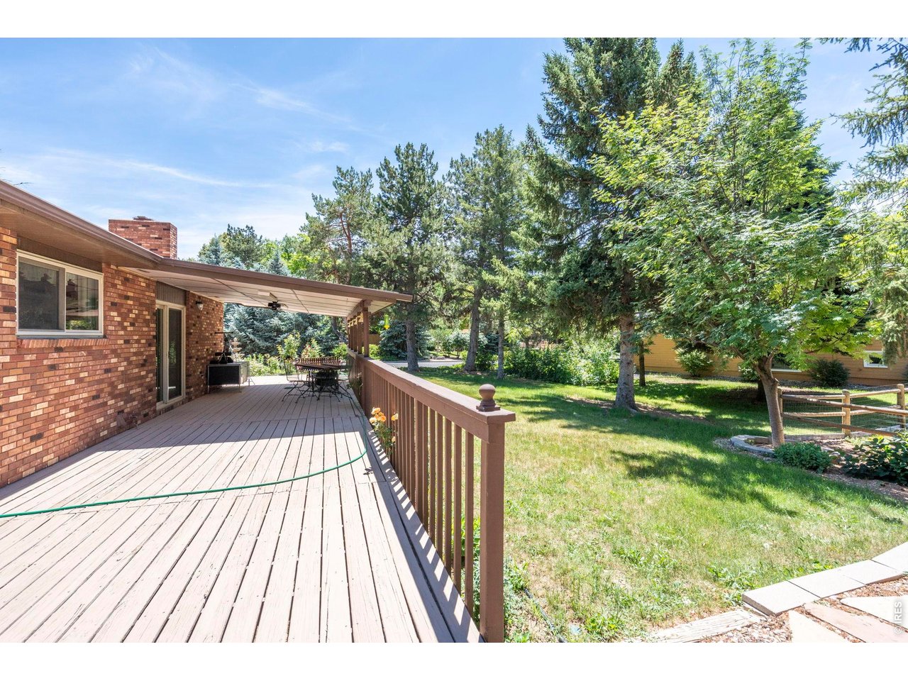 300 Ranch Acres Drive Loveland, CO 80538 - Photo 29 of 38 a balcony with wooden floor and yard in the back