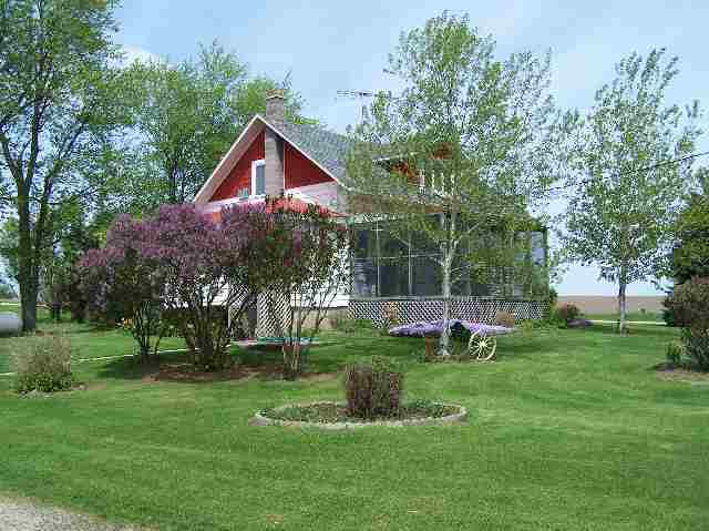 6662 North Oak Road Freeport, IL 61032 - Photo 2 of 9 a view of a house with a yard and a tree