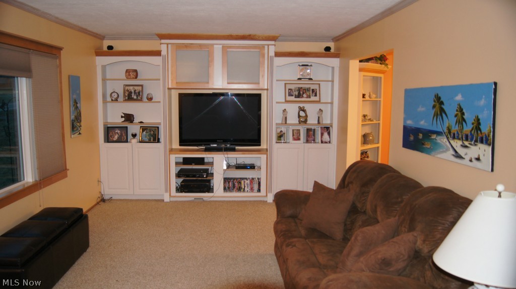 857 Renninger Road New Franklin, OH 44319 - Photo 2 of 25 Living room with crown moulding and built ins