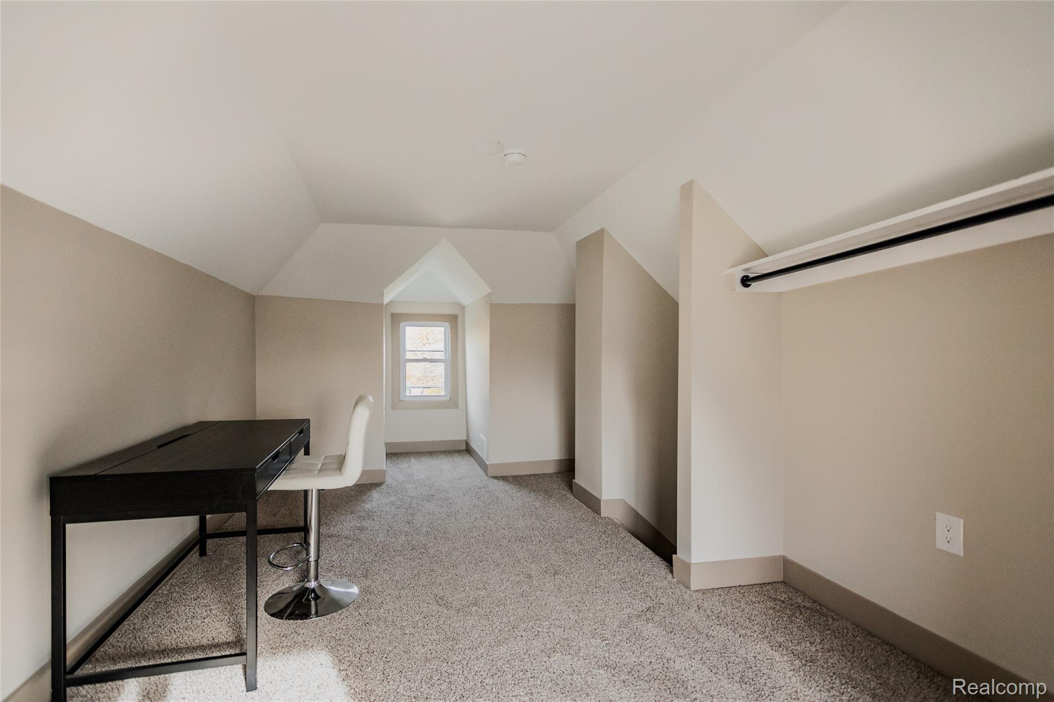 2630 Harding Street Detroit, MI 48214 - Photo 23 of 30 Carpeted room featuring a single window, sloped ceilings, and neutral wall tones