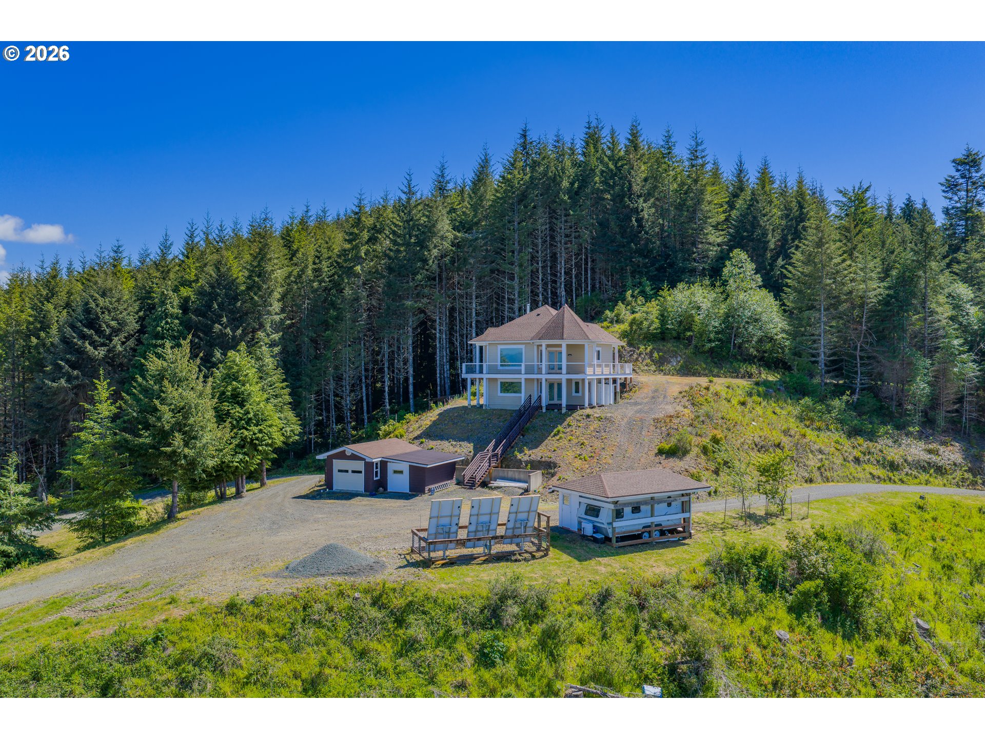 46345 Dement Creek Road Broadbent, OR 97414 - Photo 1 of 47 a view of a garden with a bench in a yard