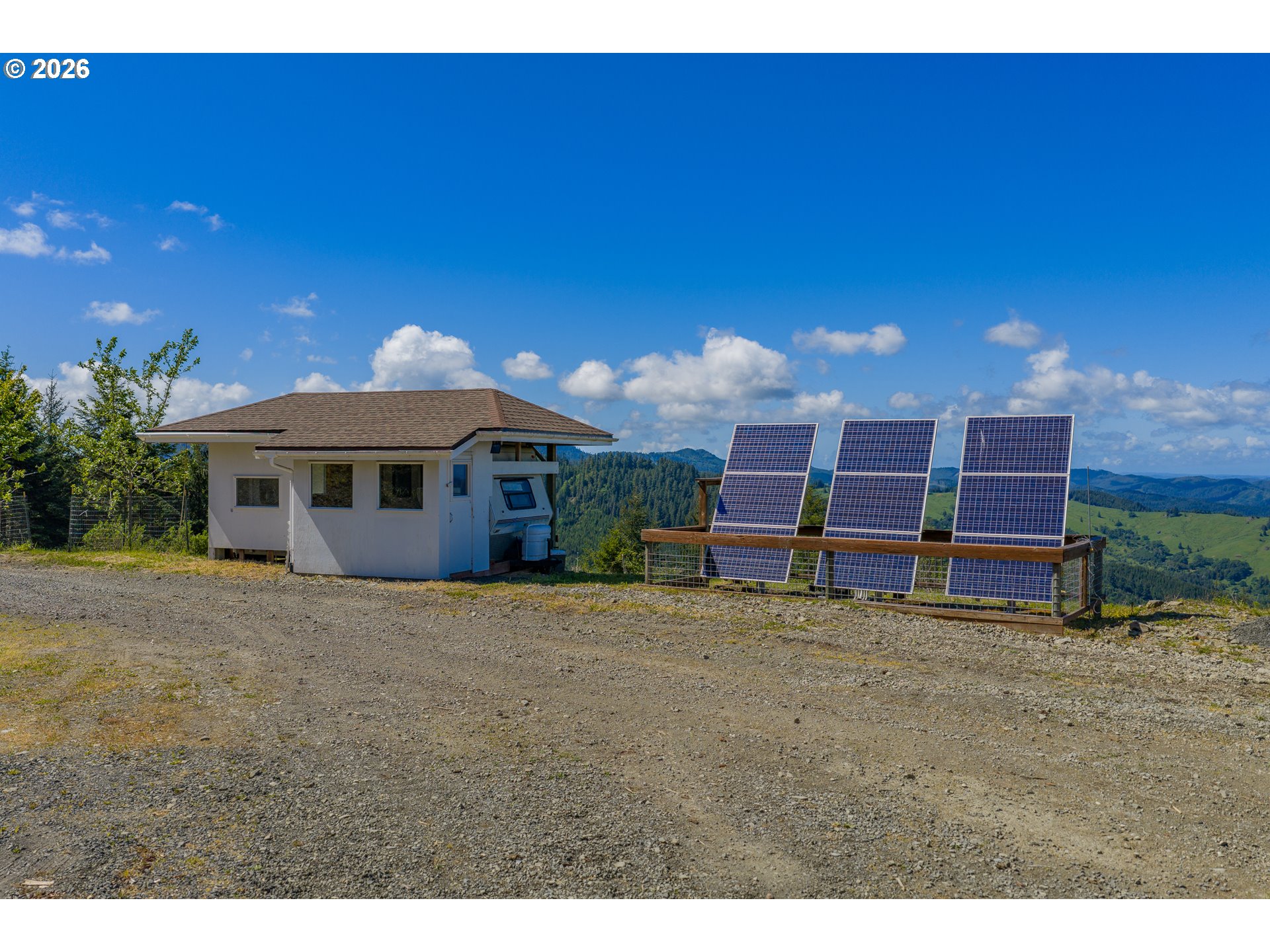 46345 Dement Creek Road Broadbent, OR 97414 - Photo 11 of 47 a view of a house with a yard and sitting area