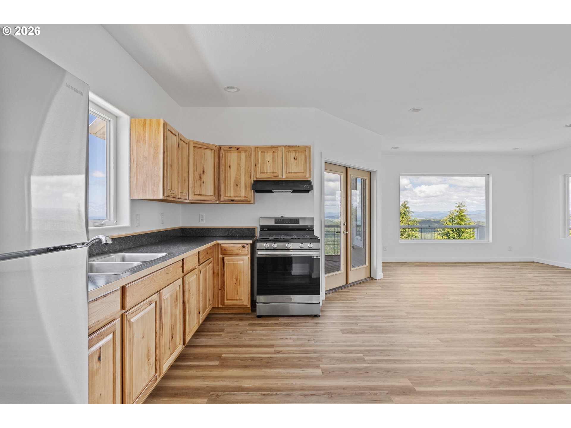 46345 Dement Creek Road Broadbent, OR 97414 - Photo 15 of 47 a kitchen with stainless steel appliances a stove a sink and a refrigerator