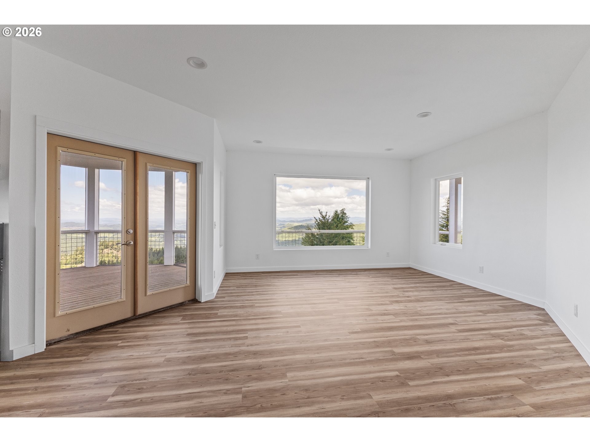 46345 Dement Creek Road Broadbent, OR 97414 - Photo 18 of 47 a view of an empty room with wooden floor and a window