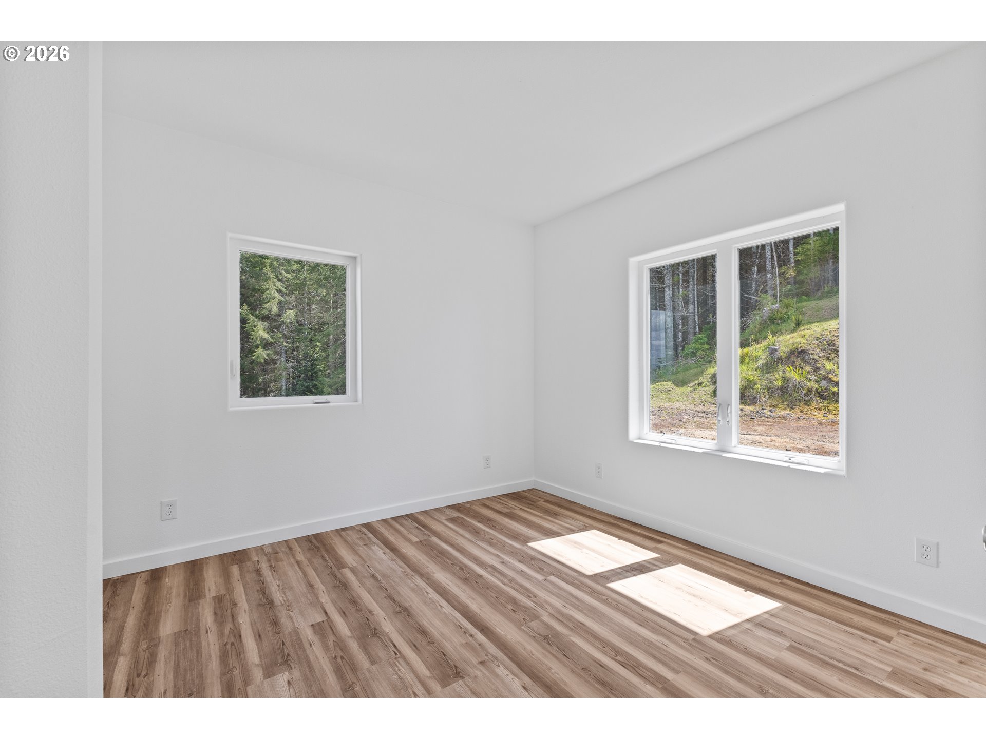 46345 Dement Creek Road Broadbent, OR 97414 - Photo 21 of 47 an empty room with wooden floor and windows