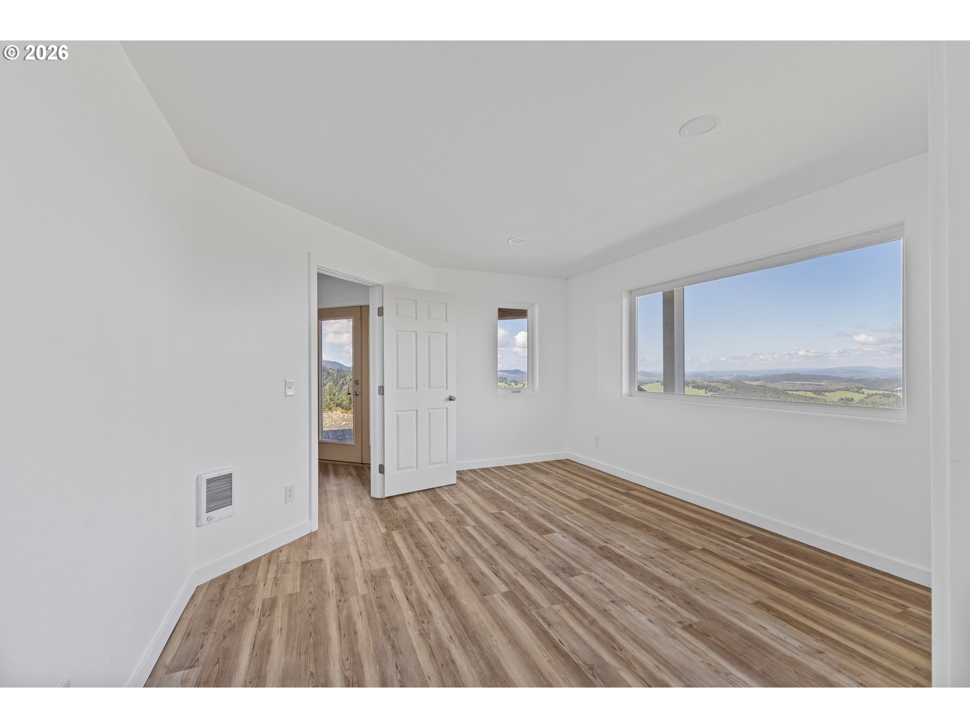 46345 Dement Creek Road Broadbent, OR 97414 - Photo 28 of 47 a view of an empty room with wooden floor and a window