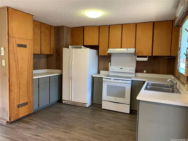 a kitchen with a refrigerator sink and cabinets
