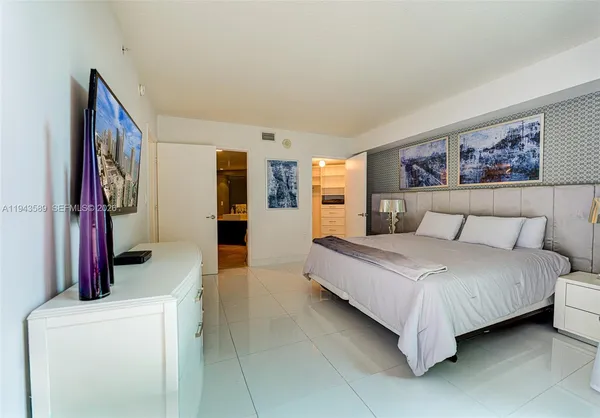 a bedroom with a bed and a couch