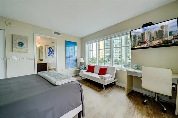 a bedroom with a bed and glass window