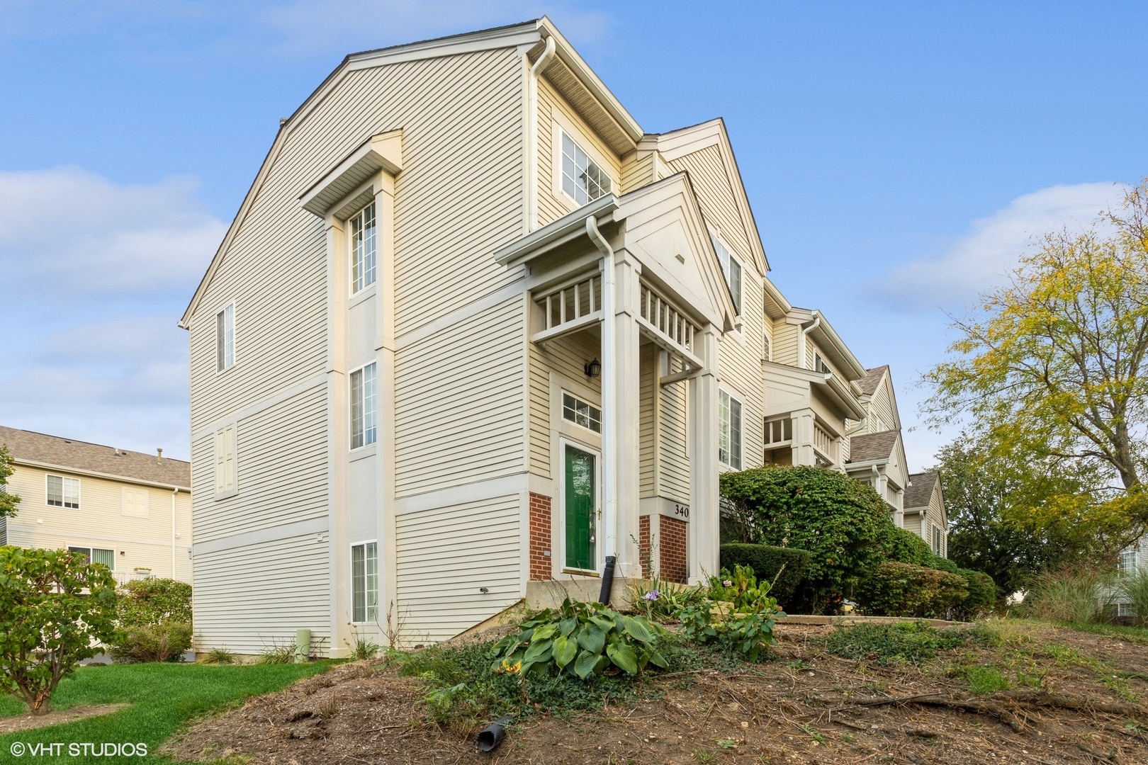 3405 Ravinia Circle, Unit 3405 Aurora, IL 60504 - Photo 1 of 1 a front view of a house with a yard