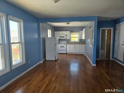 a view of a kitchen cabinets and wooden floor
