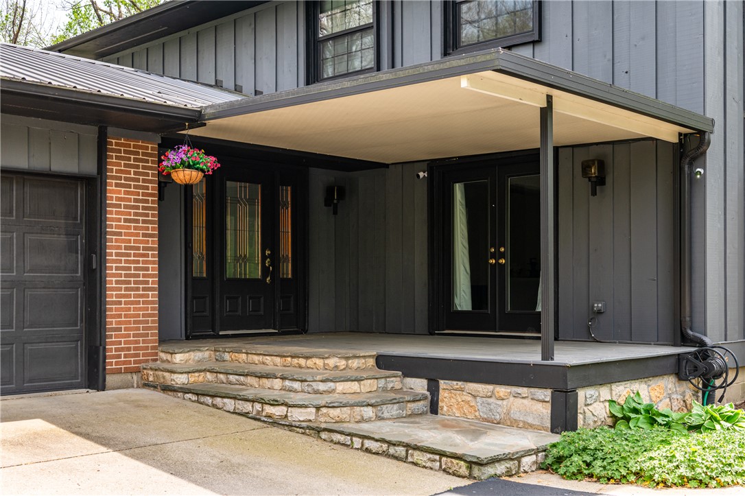 6750 Little Twin Road Germantown, OH 45327 - Photo 4 of 88 The home features a classic gray facade, inviting entrance, and stone stairs leading to the door.