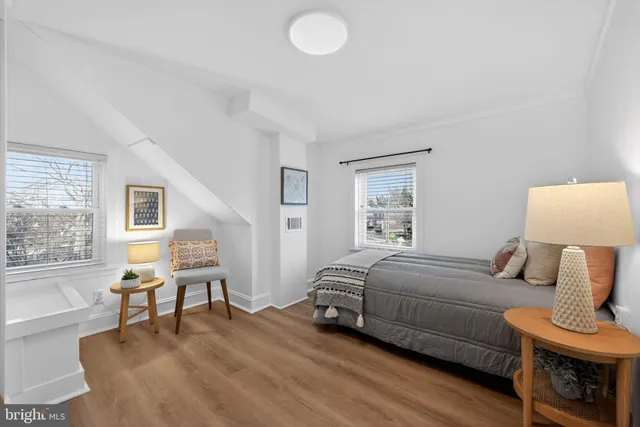 a bedroom with furniture and a window