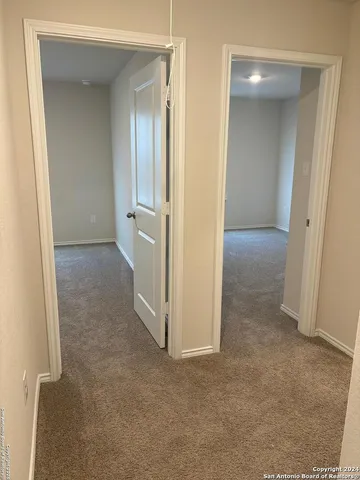 an empty room with closet and a bathroom