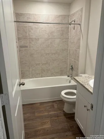 a bathroom with a sink a toilet and a bathtub