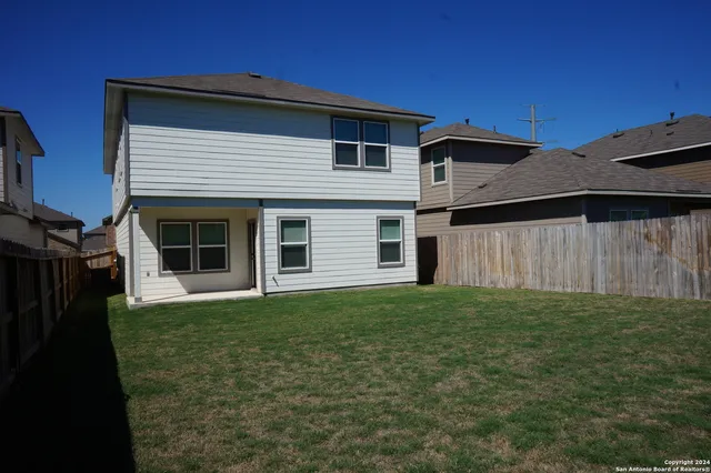 a view of a backyard of the house