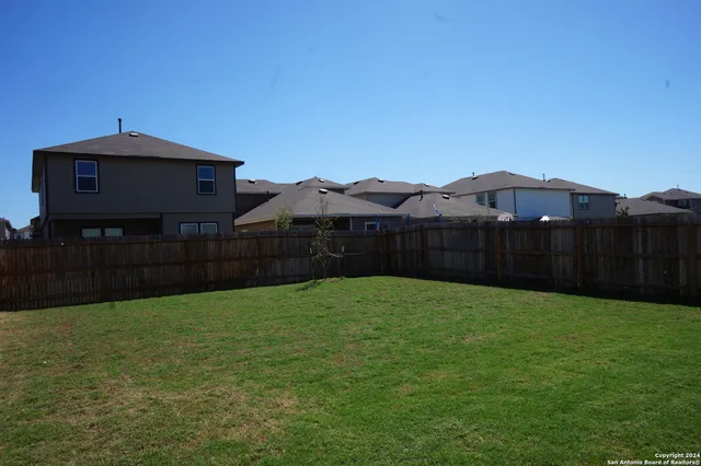 a view of a small house with a yard