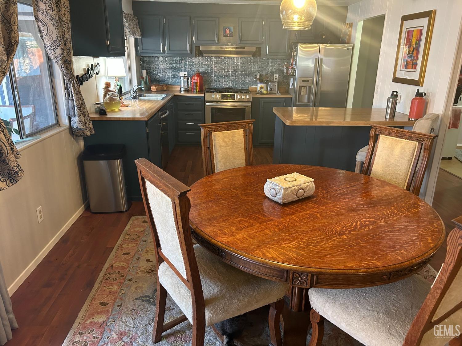 a dining room with furniture and wooden floor