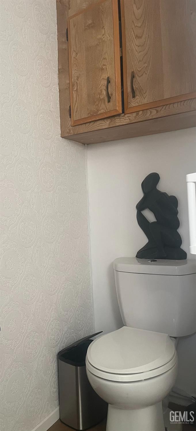 Undisclosed Address Santa Maria, CA 93454 - Photo 30 of 43 a white toilet sitting next to a wooden cabinet