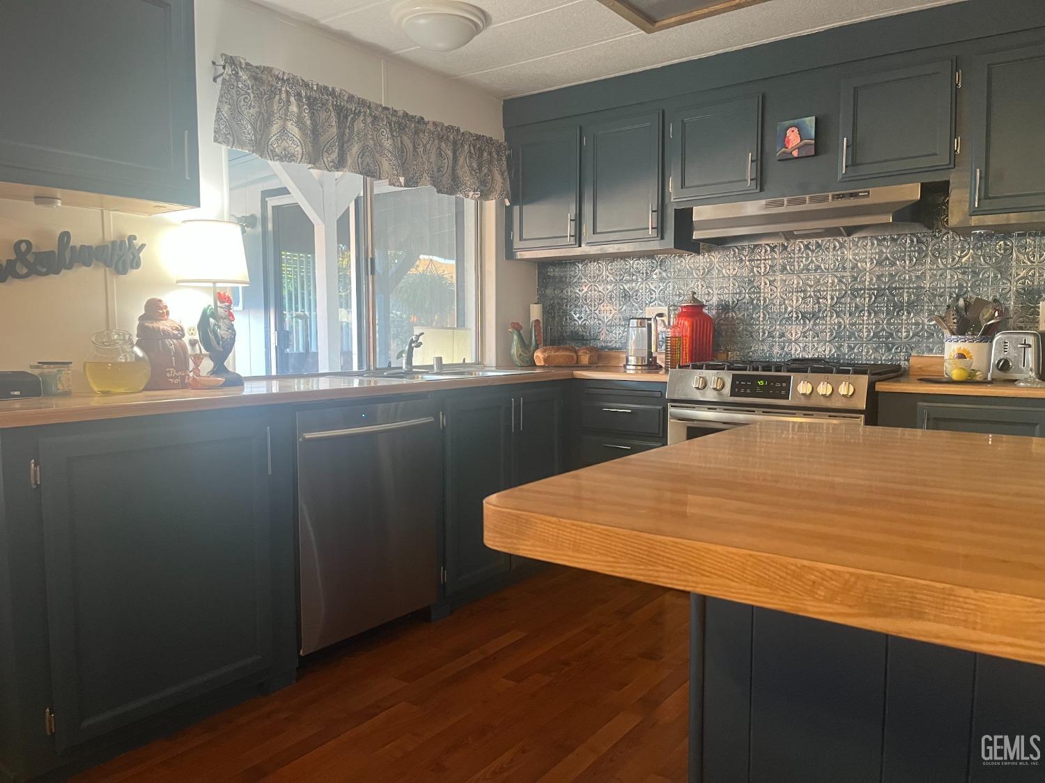 Undisclosed Address Santa Maria, CA 93454 - Photo 32 of 43 a kitchen with stainless steel appliances a sink and wooden cabinets