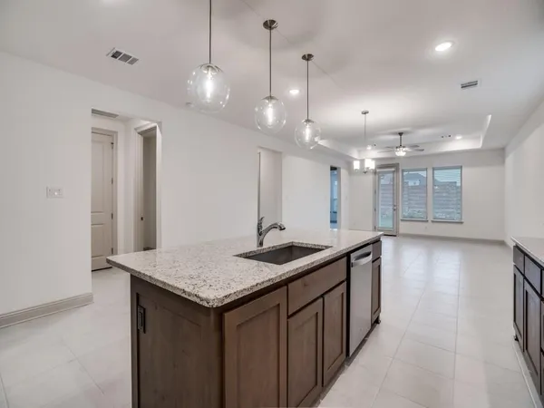 a large kitchen with stainless steel appliances granite countertop a sink a stove and a refrigerator