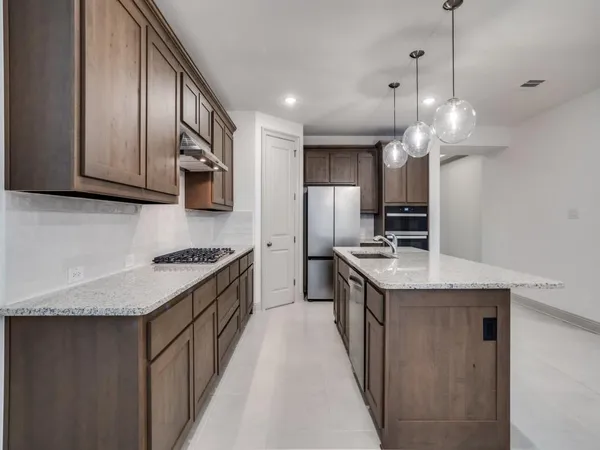 a kitchen with stainless steel appliances granite countertop a sink and a granite counter tops