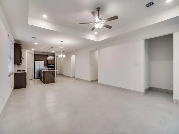 a kitchen with stainless steel appliances granite countertop a sink a stove and a wooden floors