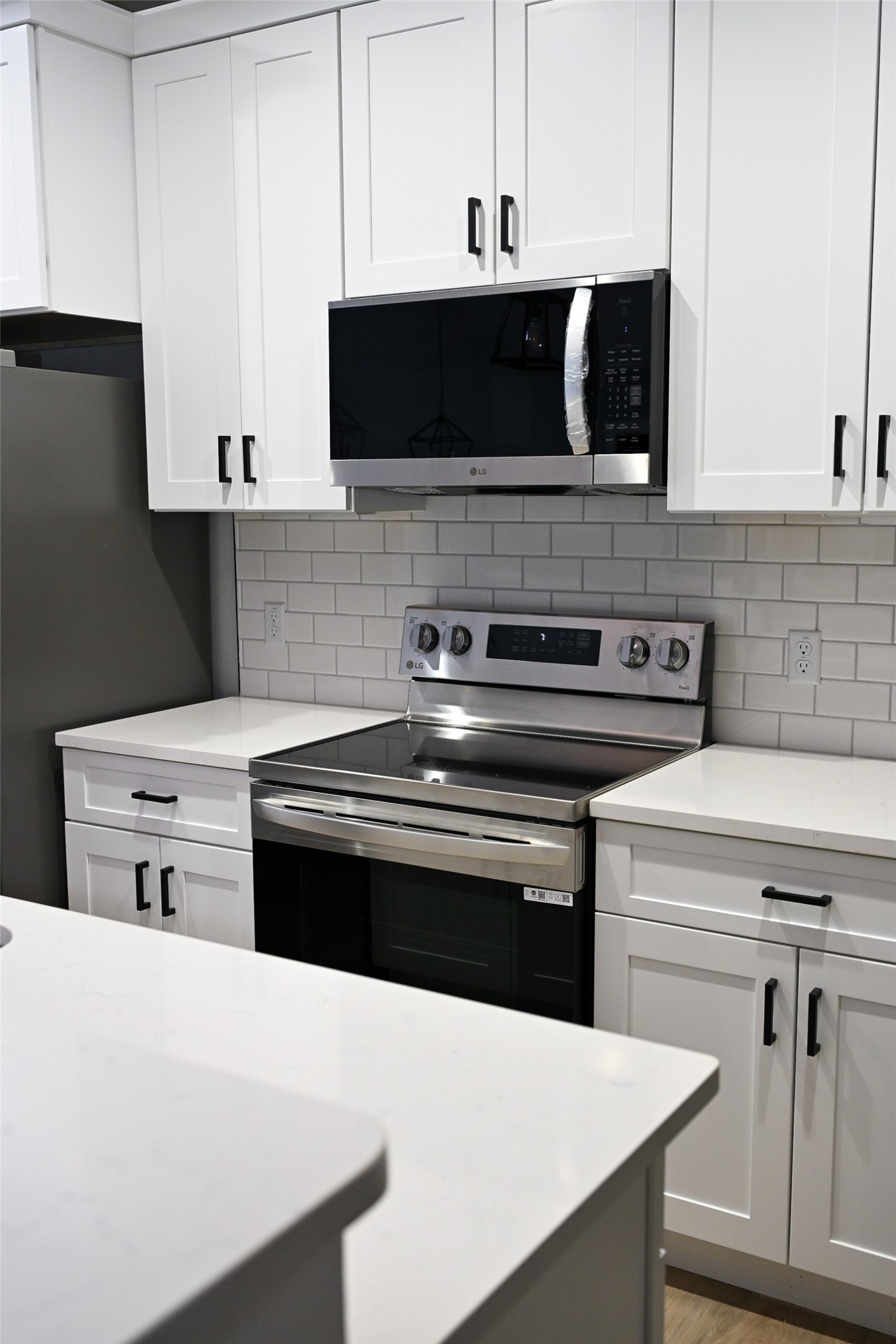 516 North Hackberry Avenue Luling, TX 78648 - Photo 26 of 36 Kitchen with stainless steel appliances, white cabinets, light stone countertops, and tasteful backsplash