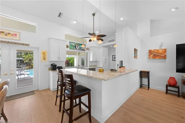 a view of kitchen with kitchen island dining table and chairs