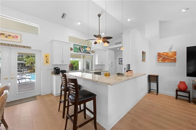 a view of kitchen with kitchen island dining table and chairs