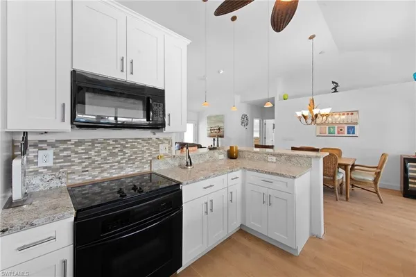 a kitchen with a sink stove and microwave