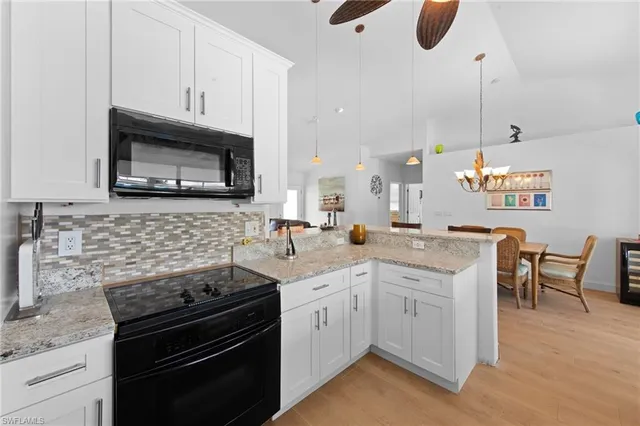 a kitchen with a sink stove and microwave