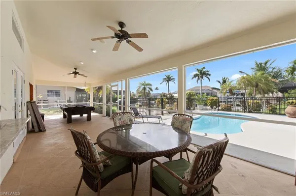 a dining room with furniture window and wooden floor