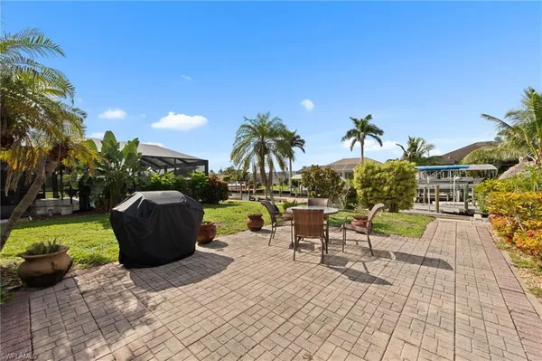 a view of a patio with table and chairs and a potted plants