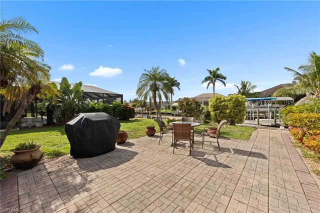 a view of a patio with table and chairs and a potted plants
