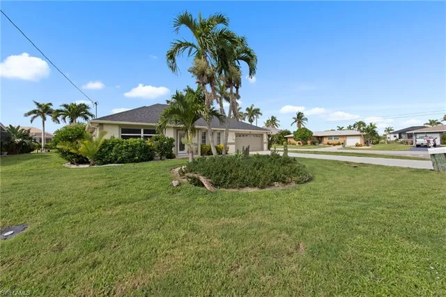 a view of a house with a big yard and potted plants